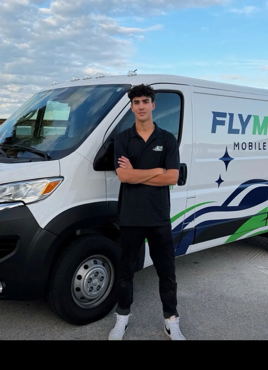 Jack Lavallee standing beside his FlyMyRide van